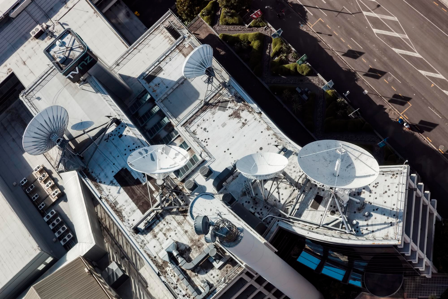 Rooftop satellite dishes and antennas supporting methane detection satelites for remote emissions monitoring and data transmission.