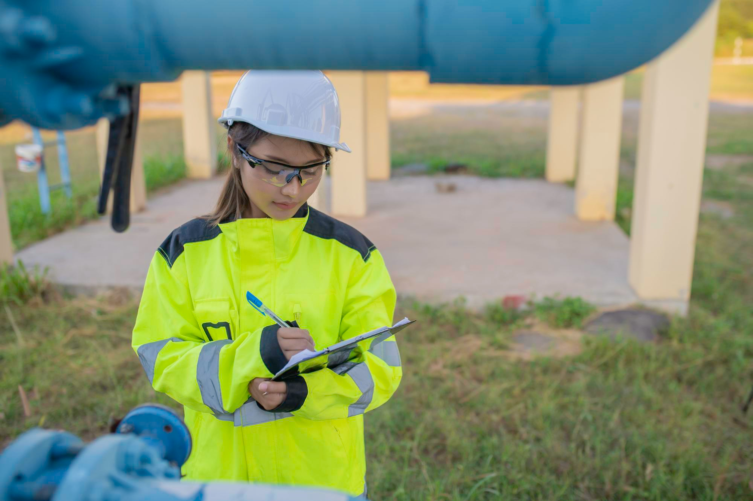 Field inspector recording readings during methane gas detection near pipeline infrastructure for leak prevention and compliance.