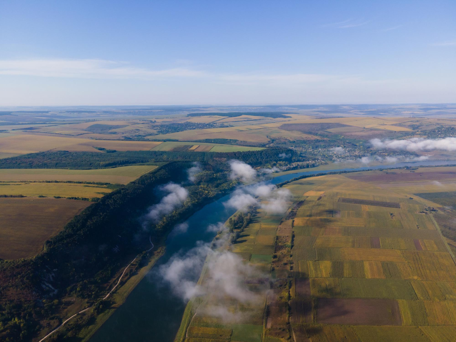 Aerial methane surveys over farmland and a winding river, supporting wide-area emissions detection and environmental monitoring.