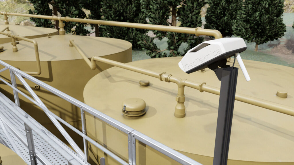 GeoTeknica methane monitoring sensor mounted near storage tanks and piping in an illustrative mock-up.